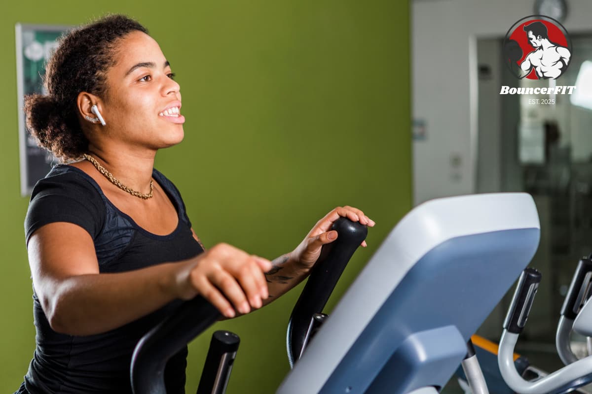 a woman working on a climber with earpods in her ears
