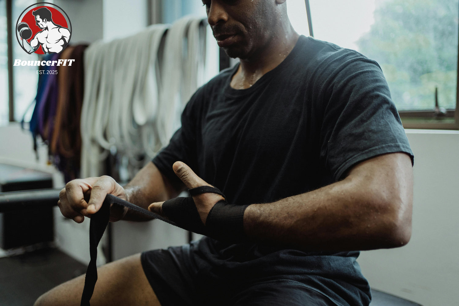 muscular black man untying his wrist band after workout
